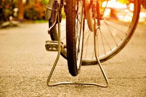 Closeup view of rear flat tire of vintage bicycle which parked on pavement beside the road. soft and selective focus. photo