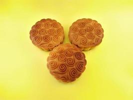 mooncake filled with nuts on yellow background.grilled, delicious, oven photo