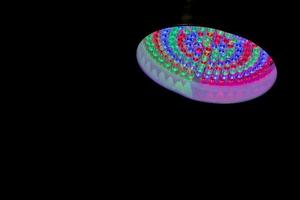 multi color led lamp on black background photo