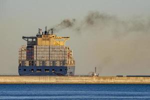 Container ship while docking in genoa harbor photo