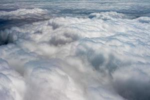 clouds in the sky from airplane window photo