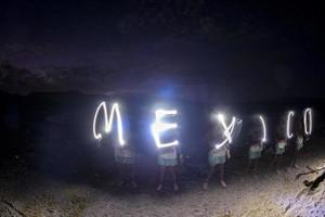 Mexico glow light painting writing on the beach photo