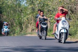 DENPASAR, BALI, INDONESIA - AUGUST 15, 2016 - Indonesia people biking photo