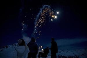 Happy new year and merry xmas fireworks on mountain snow background photo