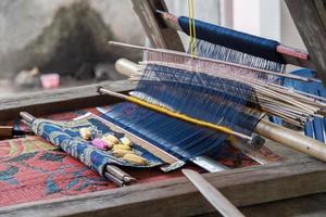 woman hand working at loom close up photo