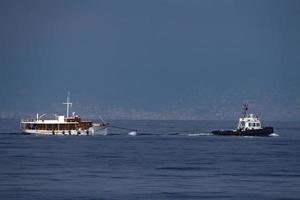 tugboat towing small boat ship photo