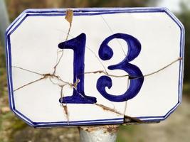 Ceramic number thirteen 13 on broken tile photo