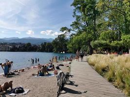 LUGANO, SWITZERLAND - JUNE 23 2019 - Lugano view cityscape from the lake full of people photo