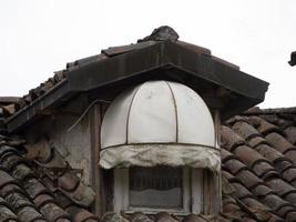 small bow window on brick house photo