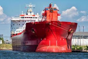 red oil tanker ship prow view on sunny day photo