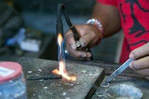 manos trabajando en el anillo de plata cerrar detalle foto