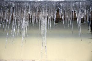 icicles on house in winter photo