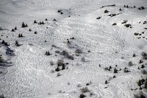 off-piste skiing tracks photo