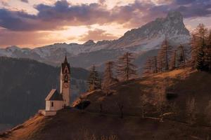 dolomites mountain church at sunset photo