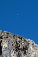 hang glider paraglider on blue sky dolomites mountains background photo