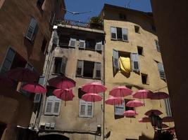 Grasse France pink umbrellas street photo