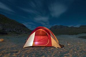 tent camp at night in the desert photo