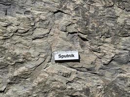 RECCO, ITALY - APRIL 26 2021 -  Sputnik Vaccine name on stone behind the church photo