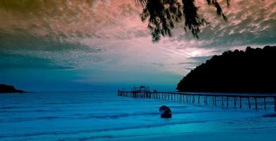 Beautiful tropical beach,Seascape in the sunset with a small boat against blue sky and cloudy sky for travel in holiday relax time as summer photo