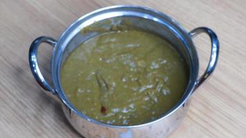 Bunch of fresh spinach Indian palak leaf,Palak paneer or Spinach and Cottage cheese curry on a dark background. Traditional Indian food. Top view photo