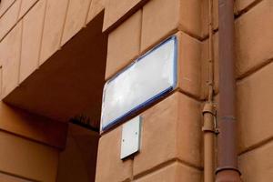 Ceramic street sign on old house wall photo