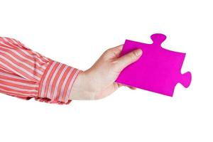 male hand holding big pink paper puzzle piece photo