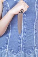 girl holding large kitchen knife photo