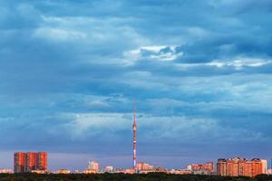 blue clouds over illuminated city on sunset photo