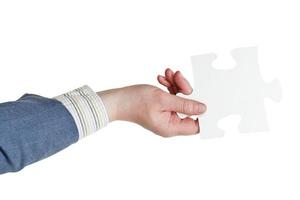 male hand holding big white paper puzzle piece photo