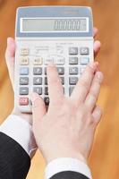 above view of calculator in accountant hands photo