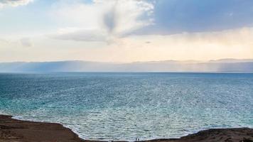 view Dead Sea from Jordan shore in winter evening photo