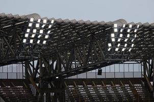 Stadium roof with floodlights in the early evening photo