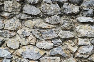 fondo de viejas piedras desiguales, una pared en un castillo o fortaleza foto