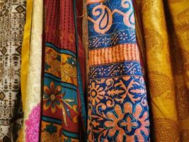 many colors indian fabric clothes at the market photo