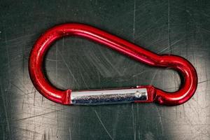 Red rusted used old karabiner close up detail photo