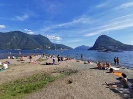 LUGANO, SWITZERLAND - JUNE 23 2019 - Lugano view cityscape from the lake full of people photo