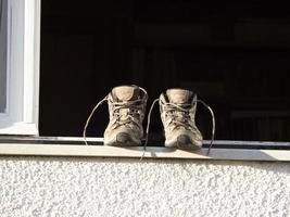 trekking shoes drying outside window photo