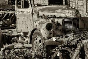 old abandoned rusted truck in b and w photo