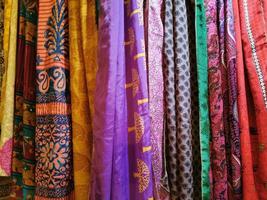 many colors indian fabric clothes at the market photo