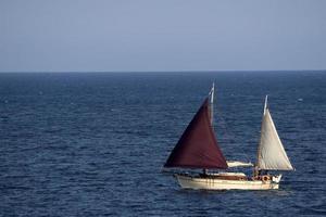 old ship vessel in the blue sea photo