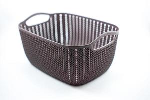 brown plastic basket with woven pattern on a white photo