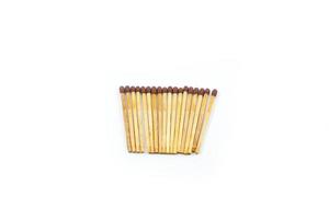 a collection of matchsticks neatly arranged isolated on a white photo