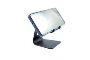 phone holder desk black aluminum metal with smartphone isolated on white photo