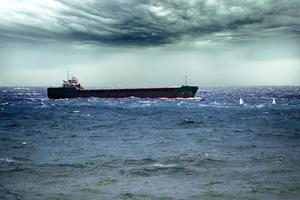 Ship in the tempest huricane cyclone photo