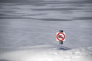 no swimming sign on snow photo