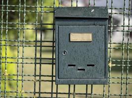 postbox on countryside house fence photo