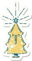 worn old sticker of a tattoo style christmas tree with star vector