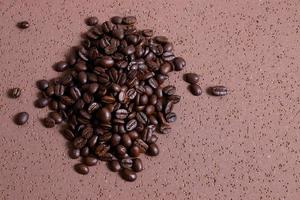 Coffee beans roasted on brown table photo