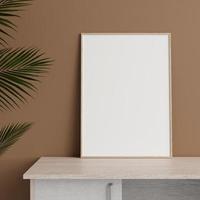 Minimalist front view vertical wooden photo or poster frame mockup leaning against wall on table with plant. 3d rendering.