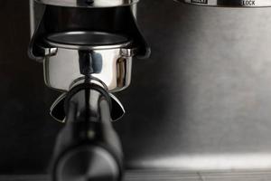 A closeup shot of an espresso coffee machine photo